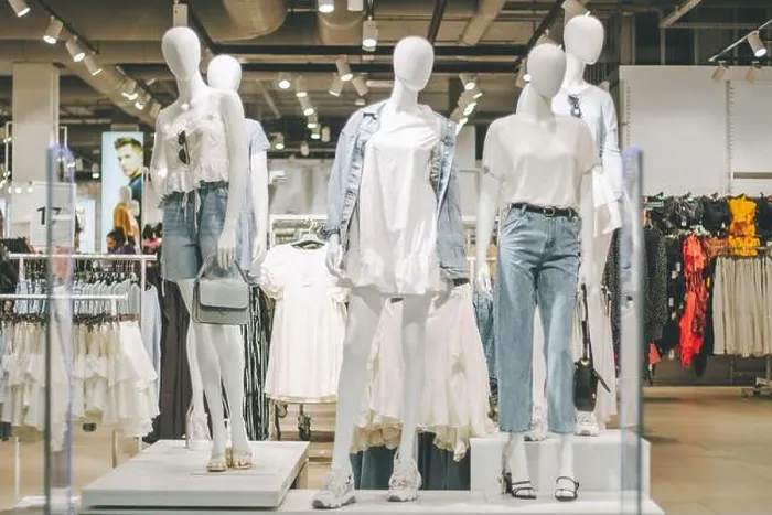 Framed Print : Mannequins in denim and white clothes in clothing store in shopping mall Framed Print : Mannequins in denim and white clothes in clothing store in shopping mall