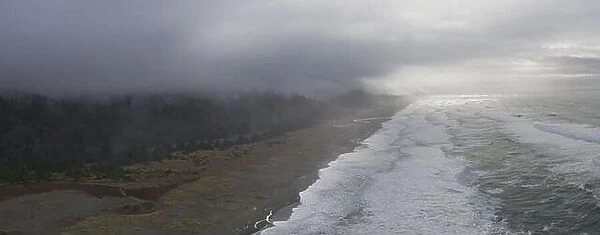 The marine layer drifts over a scenic beach in Klamath, Northern California. This region is home to the world's most beautiful temperate forests