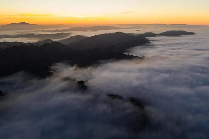 Framed Print : The marine layer, a moist air mass that develops over the ocean in the presence of a temperature inversion, seeps over the Bay Area in California Framed Print : The marine layer, a moist air mass that develops over the ocean in the presence of a temperature inversion, seeps over the Bay Area in California
