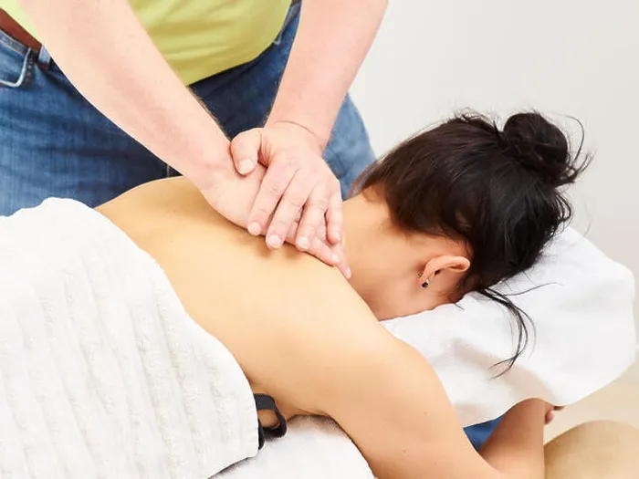 Framed Print : Massage, professional masseur and a woman customer Framed Print : Massage, professional masseur and a woman customer