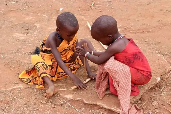 Framed Print : Massai children are pretending to ignite a fire, Kenya, Africa