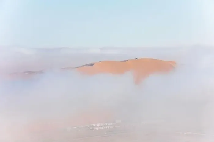Framed Print : Top of a massive sand dune emerging from a thick cloud of fog after sunrise Framed Print : Top of a massive sand dune emerging from a thick cloud of fog after sunrise