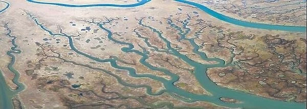 Meandering channels run through a beautiful estuary in Central California. Estuaries form when freshwater runoff meets and mixes with seawater