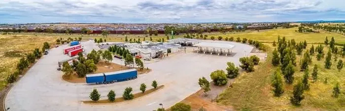Framed Print : Melbourne, Australia - Circa January 2020: Trucks parked at truck stop on Western Freeway - aerial panorama Framed Print : Melbourne, Australia - Circa January 2020: Trucks parked at truck stop on Western Freeway - aerial panorama