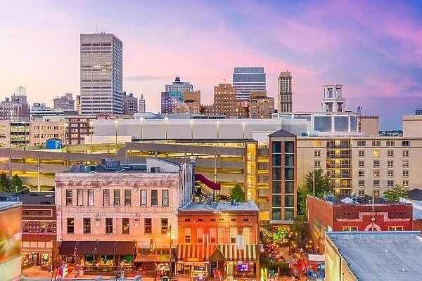 Memphis, Tennessee, USA city skyline over Beale Street at dusk