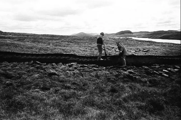 Framed Print : Men cutting peat on a stretch of land on the island of Lewis in the Outer Hebrides, Scotland Framed Print : Men cutting peat on a stretch of land on the island of Lewis in the Outer Hebrides, Scotland
