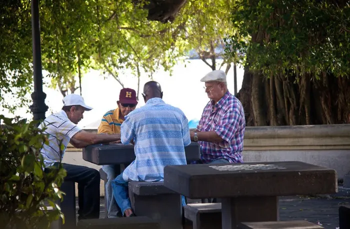Framed Print : Men playing dominoes in a shady public park in Old San Juan, Puerto Rico Framed Print : Men playing dominoes in a shady public park in Old San Juan, Puerto Rico