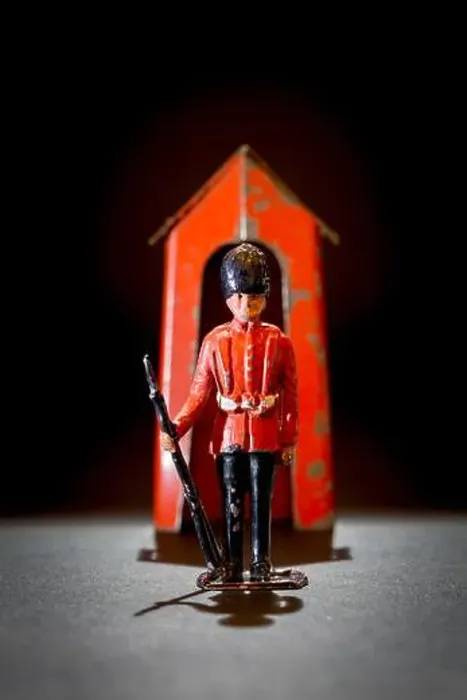 Framed Print : Metal lead toy soldier guardsman with a metal sentry box in play worn condition Framed Print : Metal lead toy soldier guardsman with a metal sentry box in play worn condition