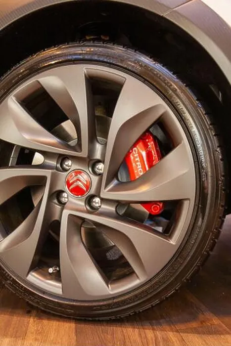 Framed Print : The metallic grey alloy wheel of a Citroen car with a bright red Citroen badge and brake caliper Framed Print : The metallic grey alloy wheel of a Citroen car with a bright red Citroen badge and brake caliper