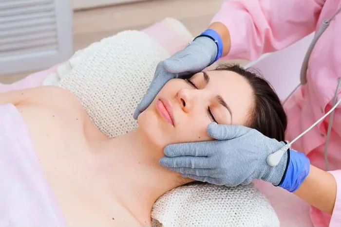 Framed Print : Micro-sensory electric microcurrent procedure bio ems for electrode stimulation of face and body with conductive gloves Framed Print : Micro-sensory electric microcurrent procedure bio ems for electrode stimulation of face and body with conductive gloves