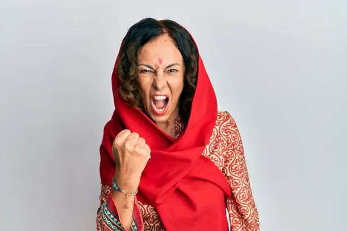 Framed Print : Middle age hispanic woman wearing tradition sherwani saree clothes angry and mad raising fist frustrated