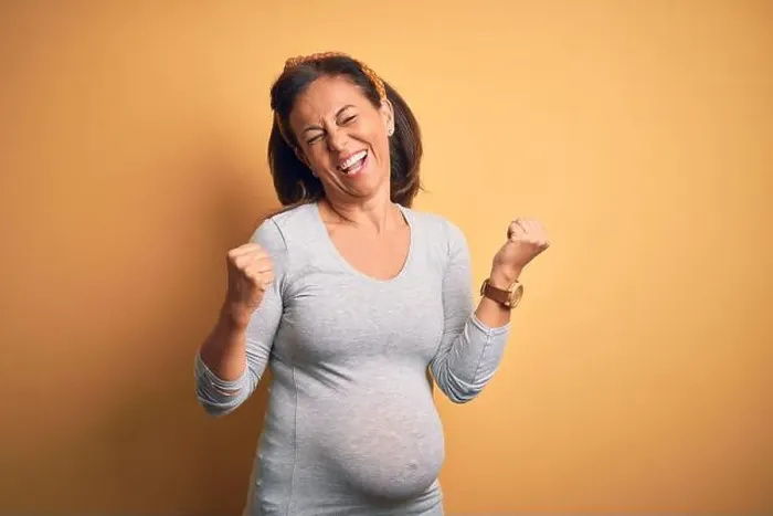 Framed Print : Middle age pregnant woman expecting baby at aged pregnancy very happy and excited doing winner gesture with arms raised Framed Print : Middle age pregnant woman expecting baby at aged pregnancy very happy and excited doing winner gesture with arms raised