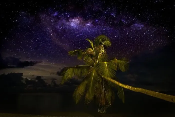 Framed Print : Milky Way over the sandy beach with palm trees, night in summer. Landscape with sea coast, beautiful blue starry sky Framed Print : Milky Way over the sandy beach with palm trees, night in summer. Landscape with sea coast, beautiful blue starry sky