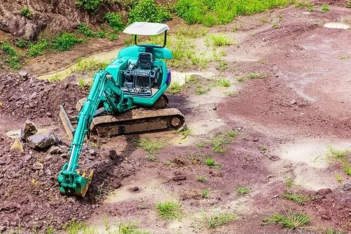 Framed Print : Mini excavator is on the ground at site construction Framed Print : Mini excavator is on the ground at site construction