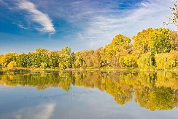 Mirror lagoon rounded by mountains, beautiful autumn lake reflection, colorful tree leaves