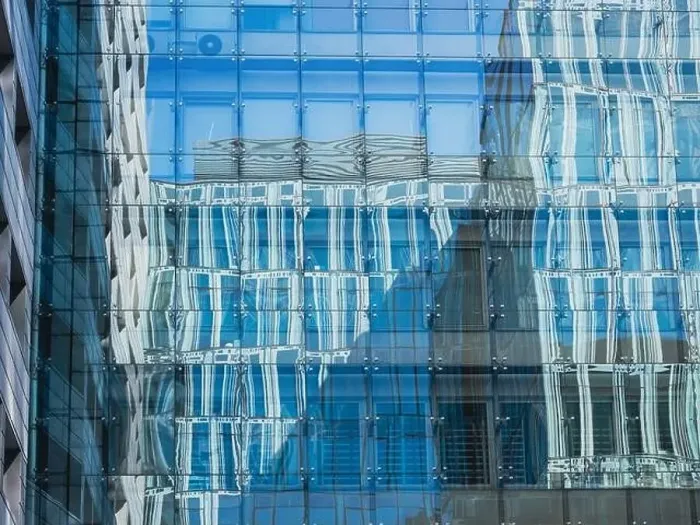 Framed Print : modern glass building mirror reflections. front view of modern glass building Framed Print : modern glass building mirror reflections. front view of modern glass building
