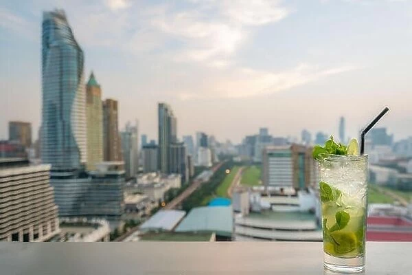 Mojito cocktail on table in rooftop bar with Bangkok city view point in Bangkok Thailand. Beautiful rooftop bar in Bangkok