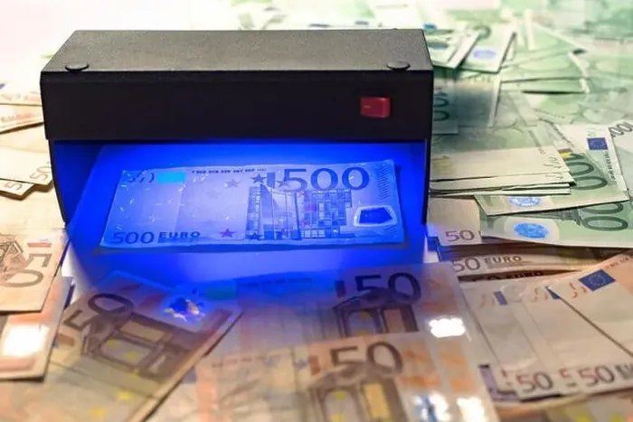 Framed Print : Money fake testing - euro banknotes authentication check in UV Currency Detector lights Framed Print : Money fake testing - euro banknotes authentication check in UV Currency Detector lights