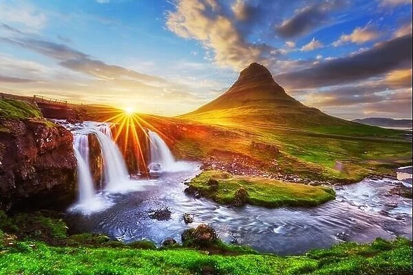 Morning landscape with rising sun on Kirkjufellsfoss waterfall and Kirkjufell mountain, Iceland, Europe