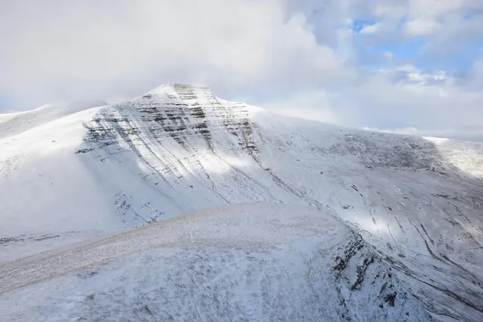Framed Print : Morning light hits the north face of snow covered Pen Y Fan in the Brecon Beacons, Wales