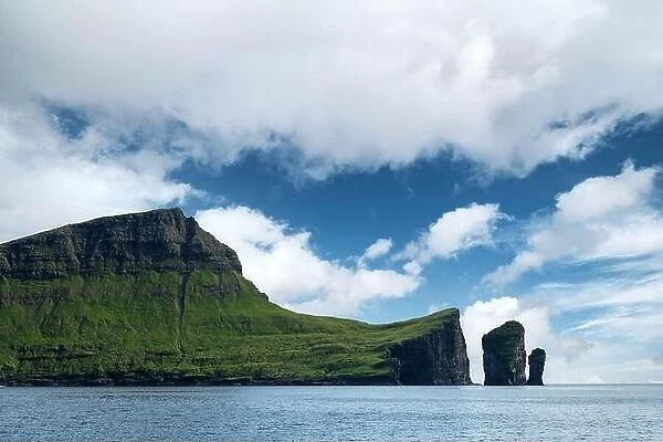 Morning view on Faroese island Vagar with blue sky and fluffy clouds. Faroe Islands, Denmark. Landscape photography