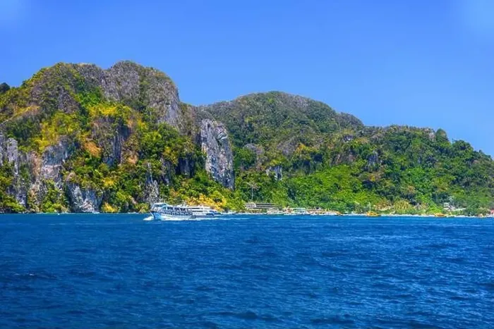 Framed Print : Motor ship in the bay of Ko Phi Phi Don Island with huge rocks and cliffs on a sunny day Framed Print : Motor ship in the bay of Ko Phi Phi Don Island with huge rocks and cliffs on a sunny day
