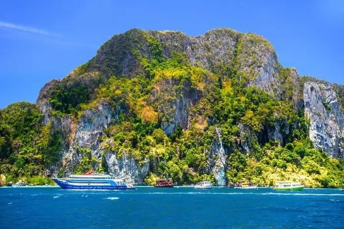 Framed Print : Motor ship in the bay of Ko Phi Phi Don Island with huge rocks and cliffs on a sunny day Framed Print : Motor ship in the bay of Ko Phi Phi Don Island with huge rocks and cliffs on a sunny day