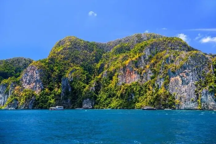 Framed Print : Motor ship in the bay of Ko Phi Phi Don Island with huge rocks and cliffs on a sunny day Framed Print : Motor ship in the bay of Ko Phi Phi Don Island with huge rocks and cliffs on a sunny day