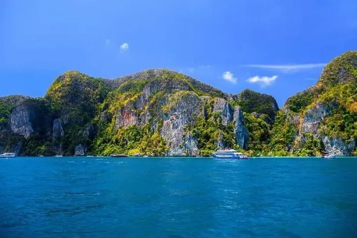 Framed Print : Motor ship in the bay of Ko Phi Phi Don Island with huge rocks and cliffs on a sunny day Framed Print : Motor ship in the bay of Ko Phi Phi Don Island with huge rocks and cliffs on a sunny day