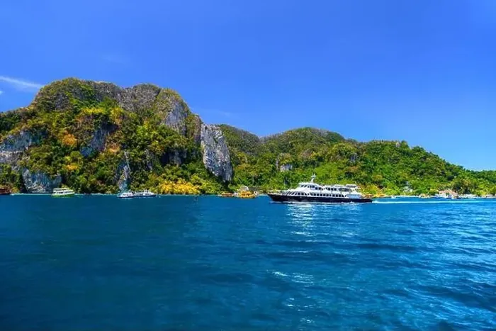 Framed Print : Motor ship in the bay of Ko Phi Phi Don Island with huge rocks and cliffs on a sunny day Framed Print : Motor ship in the bay of Ko Phi Phi Don Island with huge rocks and cliffs on a sunny day