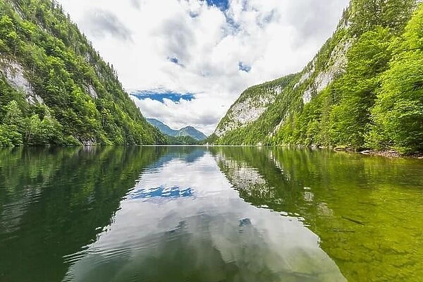 Mountain lake landscape, beautiful scenery with clouds and pine trees over lake reflection