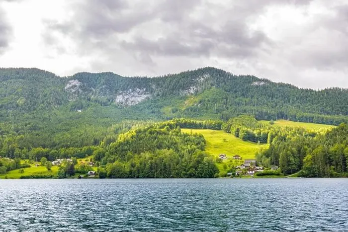 Framed Print : Mountain lake near the Euopean alps with green forest and field, cloudy day Framed Print : Mountain lake near the Euopean alps with green forest and field, cloudy day