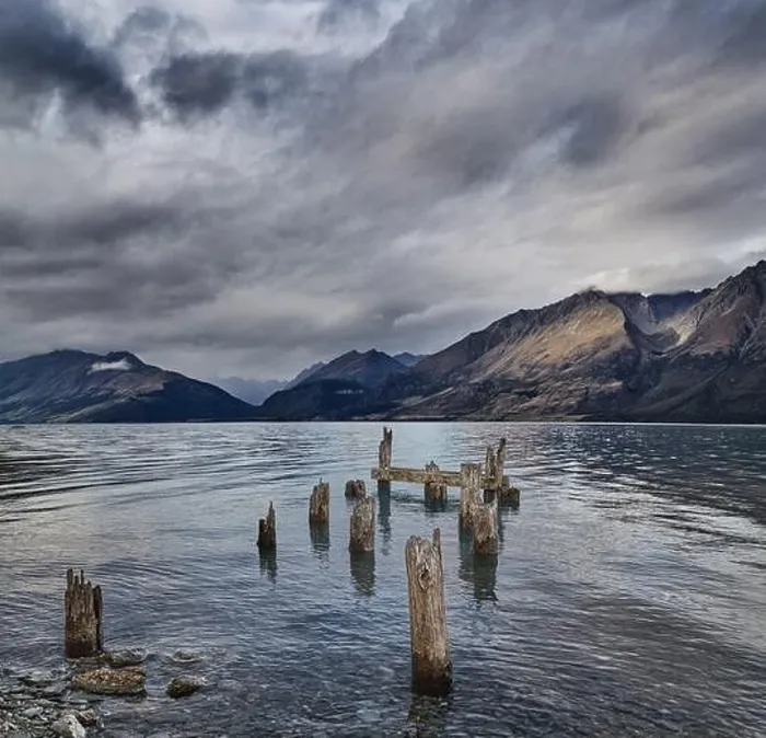 Framed Print : Mountain lake with remains of old wooden pier at windy cloudy morning Framed Print : Mountain lake with remains of old wooden pier at windy cloudy morning