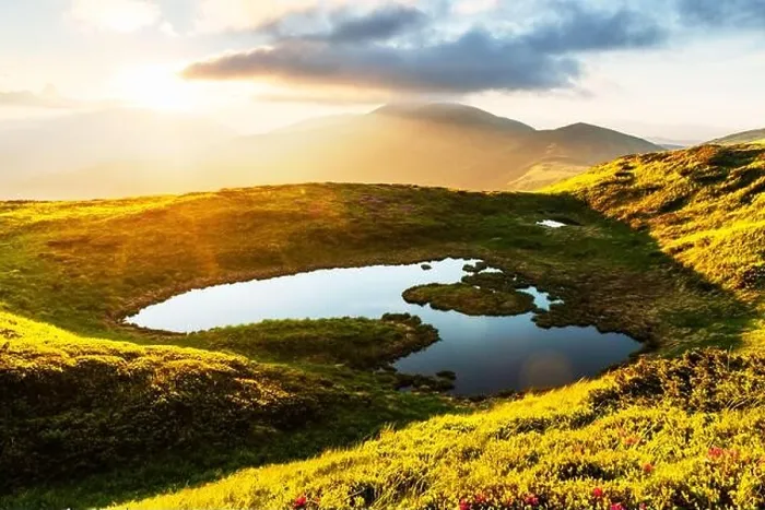 Framed Print : Mountain lake on sunrise time. Picturesque summer landscape with green mountain hills and sun rays in morning sky. Carpathian mountains Framed Print : Mountain lake on sunrise time. Picturesque summer landscape with green mountain hills and sun rays in morning sky. Carpathian mountains