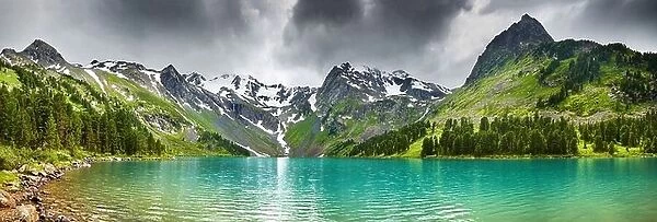 Mountain landscape with turquoise lake and cloudy sky