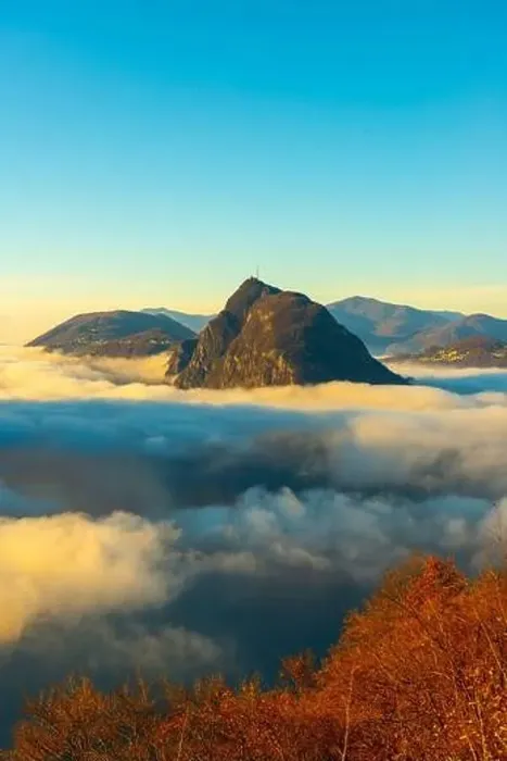 Framed Print : Mountain Peak San Salvatore Above Cloudscape with a Autumn Tree and Sunlight with Clear Sky in Lugano Framed Print : Mountain Peak San Salvatore Above Cloudscape with a Autumn Tree and Sunlight with Clear Sky in Lugano