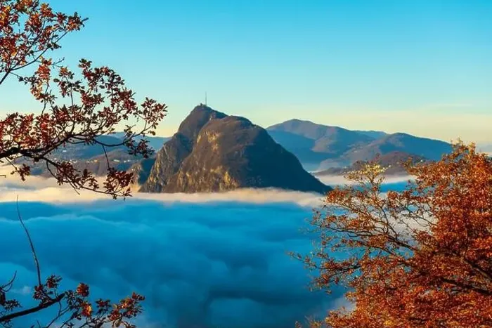 Framed Print : Mountain Peak San Salvatore Above Cloudscape with a Autumn Tree and Sunlight with Clear Sky in Lugano Framed Print : Mountain Peak San Salvatore Above Cloudscape with a Autumn Tree and Sunlight with Clear Sky in Lugano