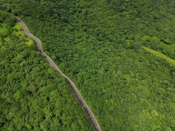 Framed Print : Mountain road on green hill jungle background on sunny day aerial drone view Framed Print : Mountain road on green hill jungle background on sunny day aerial drone view