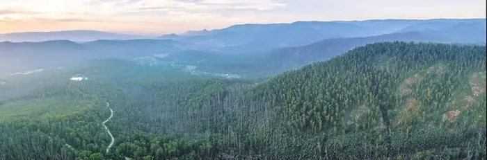 Framed Print : Mountains and eucalyptus forest at dusk - aerial panoramic landscape Framed Print : Mountains and eucalyptus forest at dusk - aerial panoramic landscape