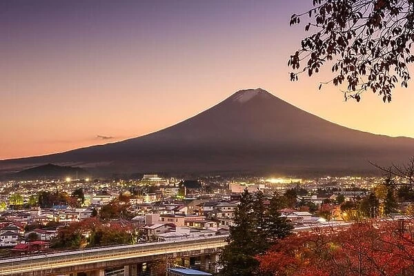 Mt. Fuji rises over Fujiyoshida, Japan in autumn