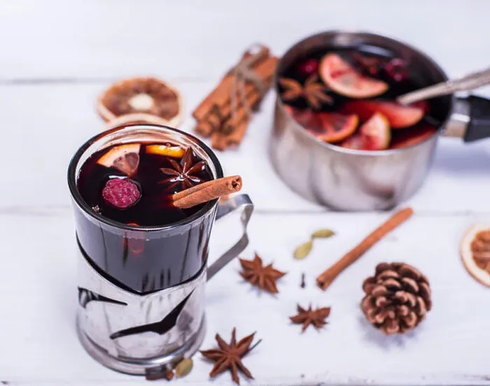 Framed Print : mulled wine in a glass with an iron cup holder on a white wooden background, top view Framed Print : mulled wine in a glass with an iron cup holder on a white wooden background, top view