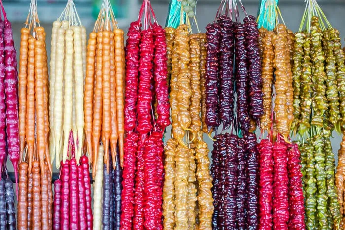 Framed Print : Multicolored delicious fresh Georgian Sweets Churchkhela hanging in the market Framed Print : Multicolored delicious fresh Georgian Sweets Churchkhela hanging in the market