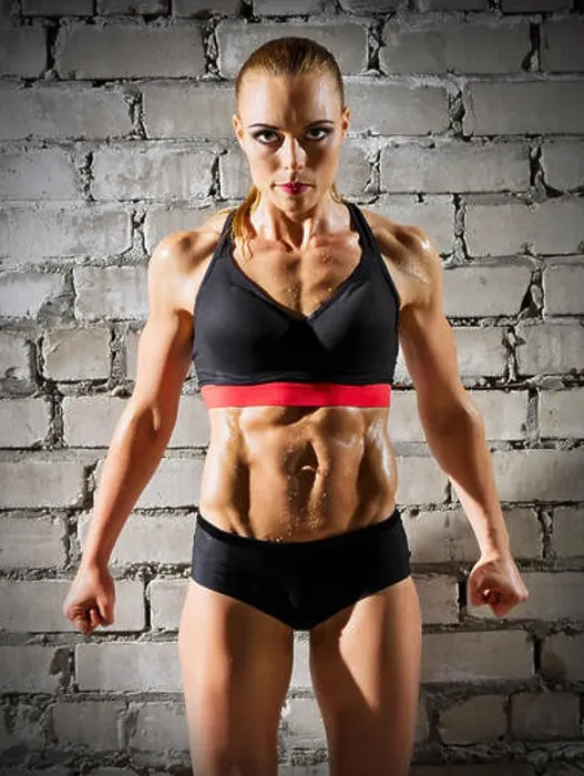 Framed Print : Muscular woman on grey brick wall (normal version) Framed Print : Muscular woman on grey brick wall (normal version)