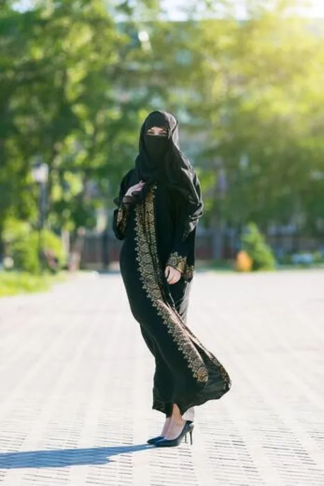 Framed Print : Muslim woman in full growth, urban lifestyle. Oriental girl in festive national dress in a European city Framed Print : Muslim woman in full growth, urban lifestyle. Oriental girl in festive national dress in a European city