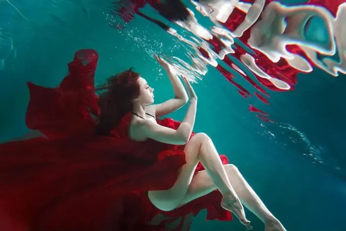 Framed Print : Mystical underwater portrait of a beautiful young woman in a red dress