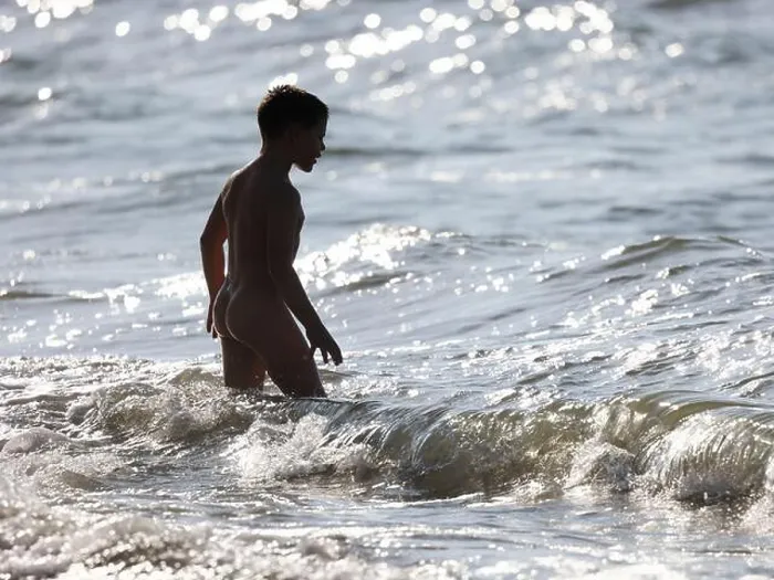 Framed Print : Naked young boy entering to sea, in sea waves Framed Print : Naked young boy entering to sea, in sea waves