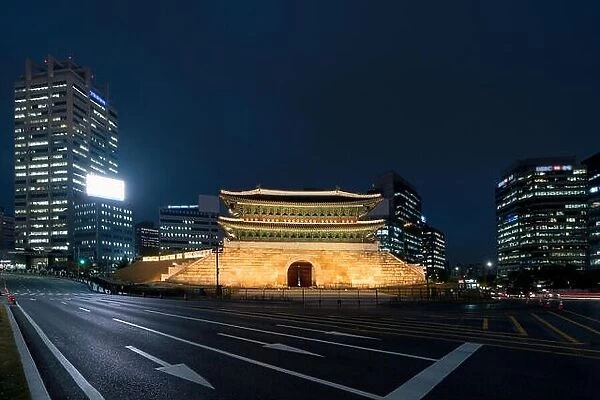 Namdaemun gate in Seoul business district area skyline view from street at night in Seoul, South Korea. Asian tourism, modern city life, or business f