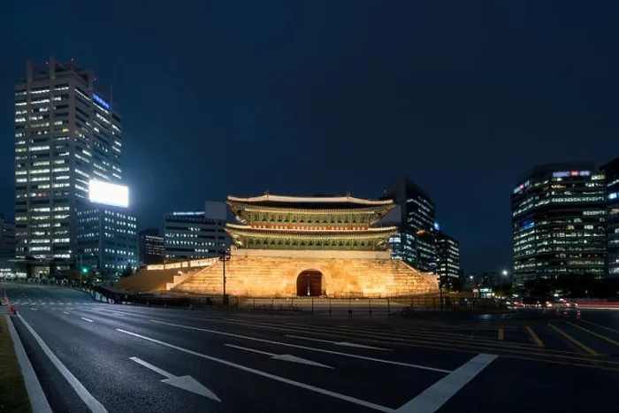 Framed Print : Namdaemun gate in Seoul business district area skyline view from street at night in Seoul, South Korea. Asian tourism, modern city life, or business f