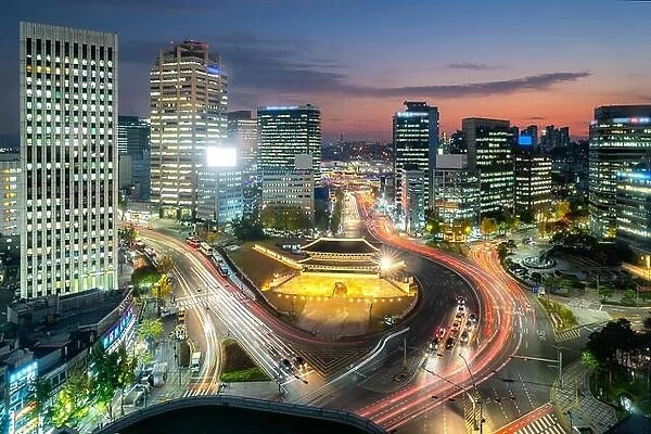 Namdaemun gate with Seoul business district at night in Seoul, South Korea