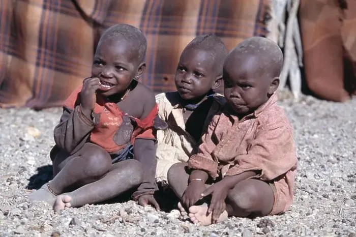 Framed Print : Namibia. Himba tribe village. Children sitting outside Framed Print : Namibia. Himba tribe village. Children sitting outside